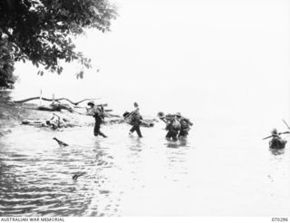 WEBER'S POINT, NEW GUINEA, 1944-02-09. "D" COMPANY, 30TH INFANTRY BATTALION MEMBERS CROSSING A RIVER NEAR WEBER POINT, DURING THE ADVANCE FROM ROINJI (2) TO LINK WITH AMERICAN TROOPS AT YAGOMAI. ..