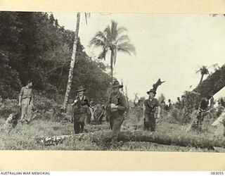 BABIANG, NEW GUINEA. 1944-11-08. A PATROL FROM A TROOP, ANGAU ATTACHED 2/10 COMMANDO SQUADRON HEADING ALONG THE OLD GERMAN TRACK TOWARDS SUAIN. IDENTIFIED PERSONNEL ARE:- LIEUTENANT A.G. MACKINNON ..