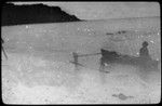 Man sitting on fishing canoe