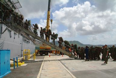 US Marine Corps (USMC) Marines assigned to the 31st Marine Expeditionary Unit (31st MEU) board the US Navy (USN) Dock Landing Ship, USS HARPERS FERRY (LSD 49) at Apra Harbor, Guam, during the Amphibious Ready Groups Spring Patrol