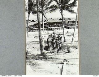 PAPUA, NEW GUINEA. 1942-07-20. AUSTRALIAN TROOPS RETURNING FROM A PATROL THROUGH A NATIVE VILLAGE
