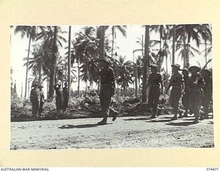 MADANG, NEW GUINEA. 1944-07-02. PERSONNEL OF A COMPANY, 24TH INFANTRY BATTALION GIVE "EYES RIGHT" TO VX24325 BRIGADIER H.H. HAMMER, DSO, COMMANDING, 15TH INFANTRY BRIGADE DURING THE MARCH PAST AT ..