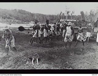 NATIVE WORKERS BURYING AMERICAN DEAD REMOVED FROM BOUGAINVILLE ISLAND FOR RE-INTERNMENT AT MUNDA CEMETERY