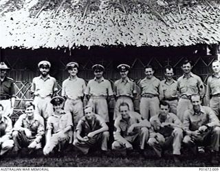 LUNGGA, GUADALCANAL, SOLOMON ISLANDS, 1944-02-29. A GROUP OF OFFICERS AND OTHER RANKS AT THE HEADQUARTERS CAMP OF THE DEPUTY SUPERVISING INTELLIGENCE OFFICER (DSIO), NAVAL INTELLIGENCE DIVISION, ..