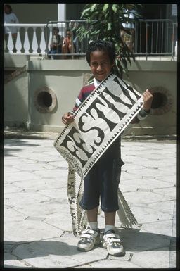 Boy holding a tapa sash during the 8th Festival of Pacific Arts, Noumea, New Caledonia