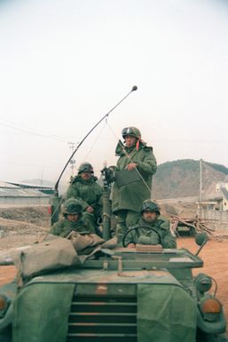 Members of the 299th Infantry, Hawaii Army National Guard, guard the command headquarters of the 1ST Battalion, 5th Infantry, 25th Infantry Division, during the joint U.S./South Korean Exercise TEAM SPIRIT'85. They are manning an M-151 light vehicle armed with an M-60 machine gun