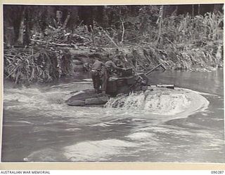 BOUGAINVILLE. 1945-03-30. WATER POURING OFF THE HULL OF A MATILDA TANK OF B SQUADRON, 2/4 ARMOURED REGIMENT, DURING THE CROSSING OF THE PURIATA RIVER. THE TANKS ARE PART OF A MOVE FORWARD TO ..