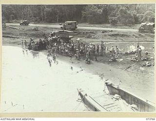 LAE, NEW GUINEA. 1944-06-08. SPECTATORS LINING VOCO BEACH DURING A SPORTS CARNIVAL HELD BY MEMBERS OF THE 2/7TH ADVANCED WORKSHOP ON THE DAY OF THEIR FIRST ANNIVERSARY