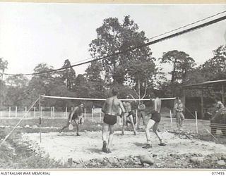 LAE BASE AREA, NEW GUINEA. 1944-12-04. THE OFFICER- IN- CHARGE AND PERSONNEL OF THE 2/77TH LIGHT AID DETACHMENT ON THE UNIT BADMINTON COURTS. IDENTIFIED PERSONNEL ARE:- VX112084 CAPTAIN A.L. KONG, ..