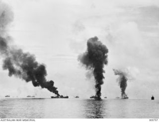 GUADALCANAL, BRITISH SOLOMON ISLANDS PROTECTORATE. 1942-08-08. THE AMERICAN TRANSPORT GEORGE F ELLIOTT ON FIRE AFTER A JAPANESE AIRCRAFT HAD CRASHED INTO HER SUPERSTRUCTURE IN THE COURSE OF AN ..