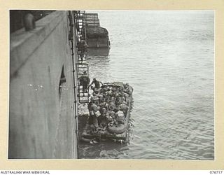 MILFORD HAVEN, LAE, NEW GUINEA. 1944-11-01. TROOPS OF THE 4TH FIELD REGIMENT COMING ABOARD THE AMERICAN LIBERTY SHIP, LINDLEY M. GARRISON FOR THE UNIT MOVEMENT TO BOUGAINVILLE ISLAND