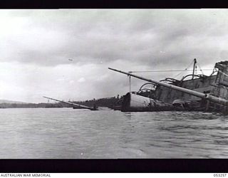 MILNE BAY, NEW GUINEA. 1943-06-29. CHINESE FREIGHTER "ASHUN" LYING ON HER SIDE AFTER BEING SUNK BY JAPANESE WARSHIPS DURING THE BATTLE FOR MILNE BAY