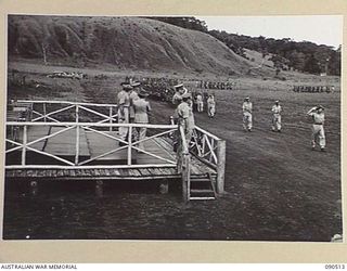 NEAR NADZAB, NEW GUINEA. 1945-03-26. A GENERAL VIEW OF THE PARADE OF 2 NEW GUINEA INFANTRY BATTALION, APPROACHING THE SALUTING DAIS, LED BY LIEUTENANT COLONEL A.C. MURCHISON, COMMANDING OFFICER OF ..