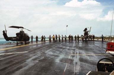 Crew members execute a foreign object damage walk-down on the flight deck of the amphibious assault ship USS GUAM (LPH 9)