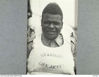 CLIFTON GARDENS, SYDNEY, AUSTRALIA. 1942-12. CLOSE UP OF A NATIVE OF THE PACIFIC ISLANDS SERVING WITH 1 AUSTRALIAN WATER TRANSPORT GROUP, ROYAL AUSTRALIAN ENGINEERS ON SMALL CRAFT, COMPLETE WITH ..