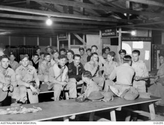 VIVIGANI, GOODENOUGH ISLAND, PAPUA. 1943-12-13. INFORMAL PORTRAIT OF TIRED CREWS OF BEAUFORT BOMBER AIRCRAFT OF NO. 100 SQUADRON RAAF AFTER A MASS STRIKE ON LAKUNAI AERODROME, RABAUL, WAITING IN ..