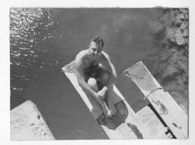 [Man Sits on Diving Board]