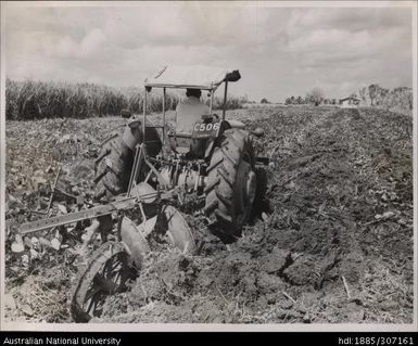 Farmer using tractor to plough field