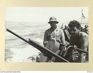 YAGOMAI, NEW GUINEA, 1944-02-10. PRIVATE NEIL WAHLMAN (1) OF MAINE, PICTURED WITH SERGEANT JOHN D. WHORTON (2) OF GEORGIA, MANNING THE TWIN 50-CALIBRE GUNS. BOTH ARE MEMBERS OF THE UNITED STATES ..