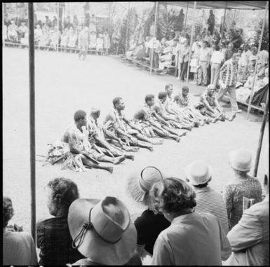 Fijian men, dressed in traditional costumes, displaying their unburnt feet to a crowd, Fiji, 1966 / Michael Terry