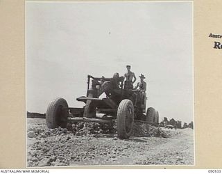 JACQUINOT BAY, NEW BRITAIN. 1945-04-13. A DIESEL POWERED ROAD GRADER OPERATED BY RAAF ENGINEERS AT WORK LEVELLING OFF AIRCRAFT DISPERSAL BAYS