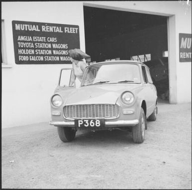 Woman getting into a rental car from Mutual Rental Fleet, Fiji, 1966, 2 / Michael Terry