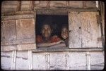 Kairiru: woman and child looking out of a window opening with shutters