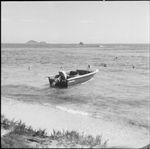 Tourists swimming around a motorboat, Vanua Levu, Fiji, November 1966 / Michael Terry