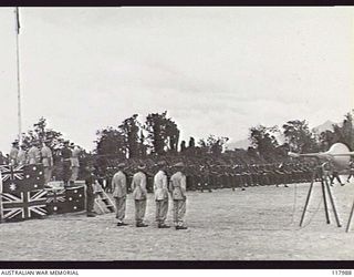 TOROKINA, BOUGAINVILLE. 1945-10-29. GENERAL SIR THOMAS A. BLAMEY, COMMANDER IN CHIEF, AUSTRALIAN MILITARY FORCES, RETURNS THE SALUTE AS PERSONNEL OF AUSTRALIAN ARMY SERVICE CORPS AND AUSTRALIAN ..