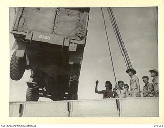 HOSKINS, NEW BRITAIN. 1944-10-08. TROOPS OF THE 36TH INFANTRY BATTALION UNLOADING AN AMBULANCE FROM THE HOLD OF THE DUTCH TROOPSHIP, "SWARTENHONDT". IDENTIFIED PERSONNEL ARE:- VX69505 SERGEANT L.S. ..