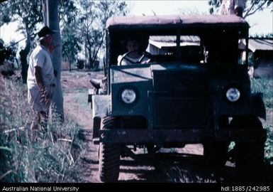 People standing next to vehicle