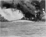 Naval photograph documenting the Japanese attack on Pearl Harbor, Hawaii which initiated US participation in World War II. Navy's caption: Keel of the capsized USS OKLAHOMA with the USS MARYLAND in the background during the Japanese attack on Pearl Harbor, Dec. 7, 1941.