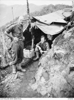 QX6030 MAJOR F. E. C. LOXTON (LEFT) THE "A" COMPANY COMMANDER OF THE 2/9TH INFANTRY BATTALION AND VX69894 PRIVATE CHARLES ROBERT LAYTON (RIGHT) OF THE BATTALION INTELLIGENCE SECTION ATTACHED TO "A" ..