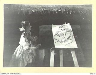 LAE, NEW GUINEA. 1944-08-11. A SISTER FROM THE 2/7TH AUSTRALIAN GENERAL HOSPITAL, THE ASSISTANT FOR THE LIGHTNING ARTIST, PREPARES TO MOVE THE PROPS FROM THE STAGE DURING A CONCERT GIVEN FOR THE ..