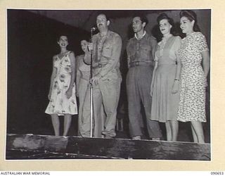 TOROKINA, BOUGAINVILLE. 1945-04-14. THE FULL CAST OF THE BOB DYER CONCERT PARTY ON STAGE AT THE CONCLUSION OF THE CONCERT FOR TROOPS AT BOSELY FIELD. IDENTIFIED PERSONNEL ARE:- DOLLY MAC (1); WILLA ..