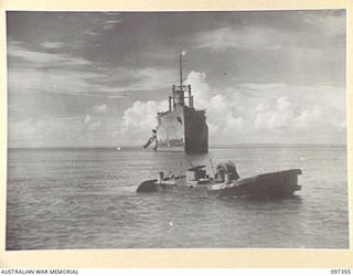 MOILA POINT, BOUGAINVILLE. 1945-09-27. THE HITATI MARU, A JAPANESE MERCHANT SHIP KNOCKED OUT BY ALLIED BOMBING AND FORCED TO RUN ASHORE. IN THE FOREGROUND IS THE WRECKAGE OF A JAPANESE BARGE. THE ..