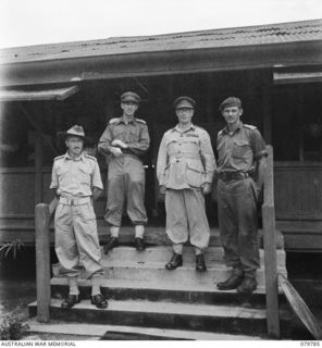 SALAMAUA, NEW GUINEA. 1945-04-24. VX13 LIEUTENANT- GENERAL S.G. SAVIGE, CB, CBE, DSO, MC, ED, GENERAL OFFICER COMMANDING NEW GUINEA FORCE (3) WITH OTHER OFFICERS. IDENTIFIED PERSONNEL ARE: MAJOR ..