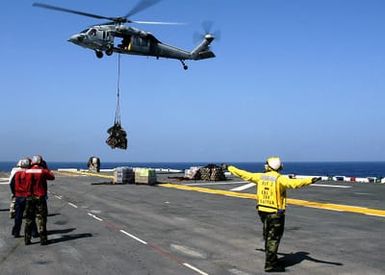 U.S. Navy Aviation Boatswain's Mate Handler Third Class Dukins Admettre signals an MH-60S Seahawk helicopter from Helicopter Sea Combat Support Squadron 26 during an underway replenishment operation on the flight deck of the Tarawa Class Amphibious Assault Ship USS SAIPAN (LHA 2) in the Gulf of Aden on Sept. 9, 2006. SAIPAN is currently underway conducting maritime security operations in the Persian Gulf. (U.S. Navy photo by Mass Communication SPECIALIST Third Class Gary L. Johnson III) (Released)