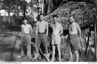 Kampti, New Guinea. Spotters with the New Guinea Air Warning Wireless Company (NGAWW) standing outside a hut. Left to right: VX132479 Signalman Thomas Henry Pike, of Brighton, Vic (later died of ..