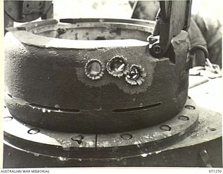 GUSIKA, NEW GUINEA. 1944-03-15. THE EFFECT OF 3 ROUNDS RAPID FIRE OF 2 POUNDER ARMOUR PIERCING SHOT ON A CUPOLA FITTED TO THE BASE OF A MATILDA TANK UNDERGOING VULNERABILITY TESTS CONDUCTED BY THE ..
