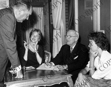 Edwin Pauley with former President Truman sitting at a table and Susan Pauley