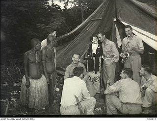 KIRIWINA, TROBRIAND ISLANDS, PAPUA. C. 1943-11-12. LEADING AIRCRAFTMAN W. EDMUNDS OF NORWOOD, SA, AN ORDERLY ROOM CLERK WITH HIS DOLL "HENRY". HE IS A VENTRILOQUIST AND HAS APPEARED AT MANY RAAF ..