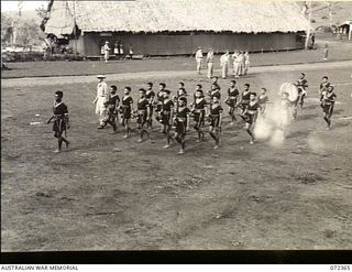 Bisiatabu, New Guinea. 1944-04-19. The bugle band of the Royal Papuan Constabulary march past the dais as PP1 Major General B. M. Morris DSO, General Officer Commanding Australian New Guinea ..