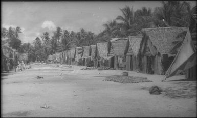 The village in black and white: note coils of pandanus leaf for mat-making (3) : Mortlock Islands, Papua New Guinea, 1960 / Terence and Margaret Spencer