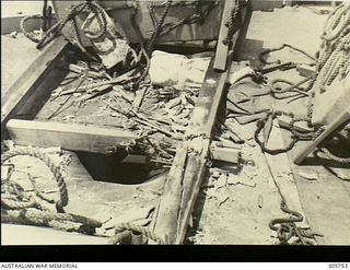 MILNE BAY. C.1943-04-14. THE BRIDGE CANOPY SHOWING THE ENTRANCE HOLE OF A BOMB WHICH PENETRATED THE BRIDGE STRUCTURE OF HMAS PIRIE BEFORE EXPLODING ON THE FORECASTLE. THE BOMB WAS DROPPED BY A ..