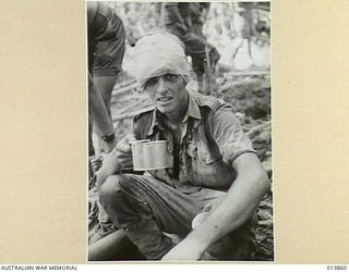1942-12-16. PAPUA. GONA. PTE. DONALD GRANT FLEMING, FROM NEWTOWN  NSW,  RECEIVED MEDICAL TREATMENT AT THE FRONT LINE. THIS PICTURE WAS TAKEN TEN MINUTES AFTER HE WAS PHOTOGRAPHED AS HE WAS GOING ..