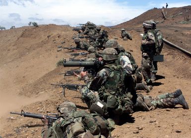 US Marines from 2nd Battalion, 3rd Marines, fire M16 rifles and M249 Squad Automatic Weapons on an assault course at Pohakuloa Training Area on the Big Island of Hawaii