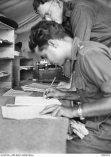 CAPE WOM, NEW GUINEA. 1945-10-19. JEMADAR CHINT SINGH, A FORMER PRISONER OF WAR, WRITING OUT HIS EVIDENCE AT HEADQUARTERS 6 DIVISION FOR THE WEWAK WAR CRIMES COMMISSION, WHICH IS TAKING SUMMARIES ..