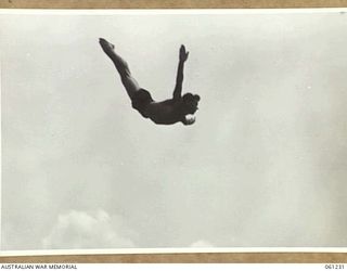 PORT MORESBY, NEW GUINEA. 1943-11-28. SERGEANT GOUGH, UNITED STATES ARMY, EXECUTES A GRACEFUL SWALLOW DIVE IN THE HIGH DIVING COMPEITION AT THE ALLIED SERVICES GRAND SWIMMING CARNIVAL