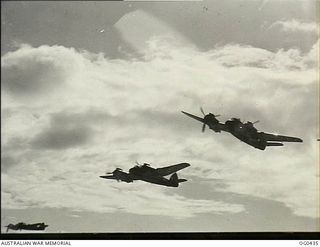 VIVIGANI, GOODENOUGH ISLAND, PAPUA. 1943-12-26. THREE AIRCRAFT OF NO. 30 (BEAUFIGHTER) SQUADRON RAAF RETURNING FROM A BARGE SWEEP OVER THE NEW BRITAIN COAST